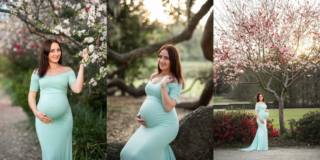 Maternity model seating on oak tree wearing mint dress