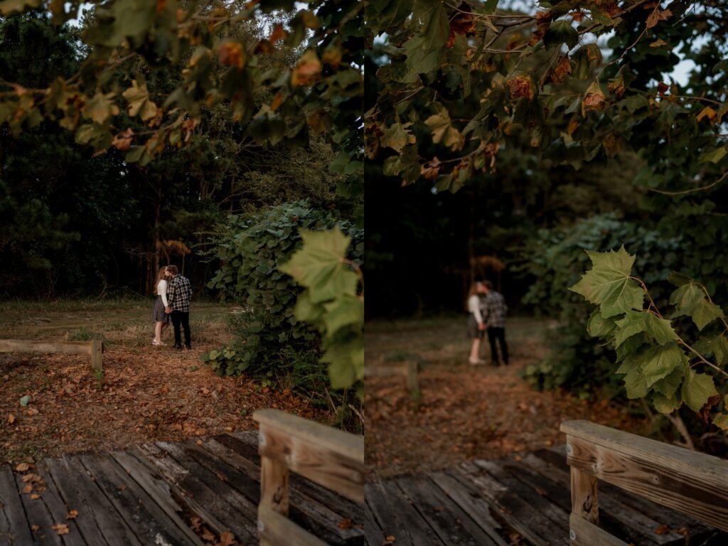 A couple stands close together in a grassy clearing surrounded by trees and foliage. They are positioned near a wooden fence. The image captures an intimate moment, with one photo providing a broader view and the other focusing more on the scene's greenery.