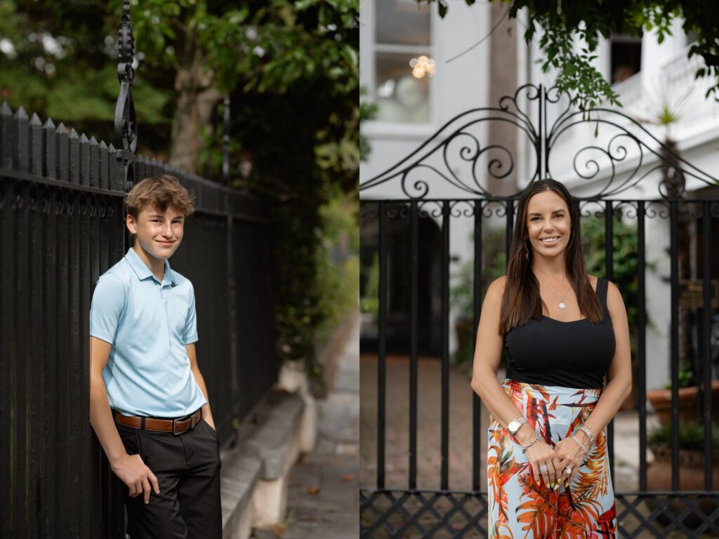 A young boy in a light blue shirt and dark pants leans against a black fence on the left, while on the right, a woman in a black top and a colorful skirt stands in front of a similar black fence. Both smile outdoors in a leafy setting.