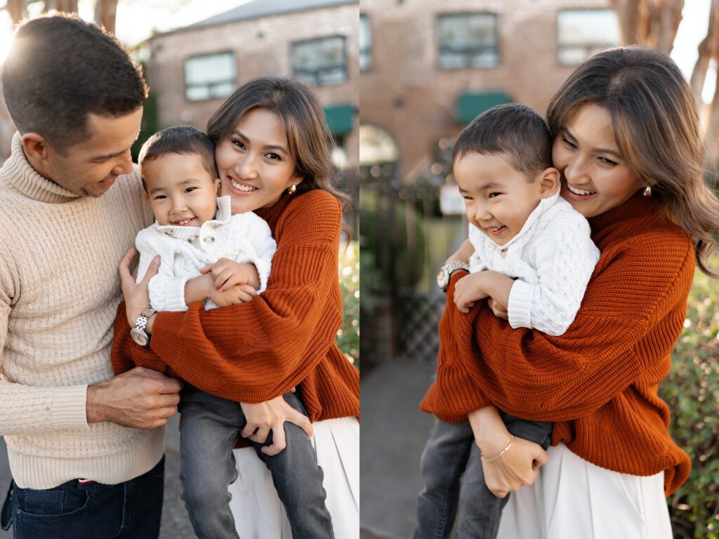 Two photos of a cheerful family outdoors: a woman in an orange sweater hugs and laughs with a young boy in a white sweater, while a man in a beige sweater looks on and smiles. Brick buildings and greenery are in the background.