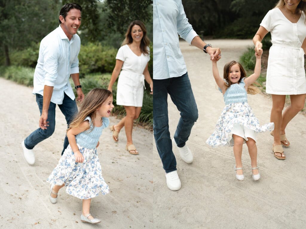 A family walks outdoors on a sandy path. On the left, a man, woman, and young girl in a blue floral dress smile as they walk. On the right, the girl laughs as the adults swing her by the arms.