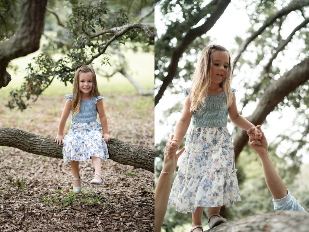 A young girl in a blue and white floral dress sits on a tree branch in one image and stands on the branch holding an adult's hands in the other, outdoors among trees.